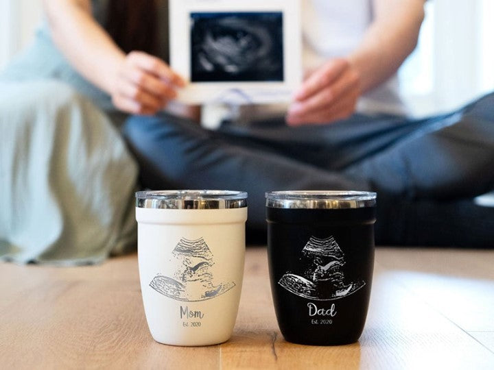 LAMOSE Personalized ultrasound engraved drinkware, showcasing black and white mugs and tumblers with custom engravings of ultrasound images and heartfelt messages as a tribute to expectant parents.