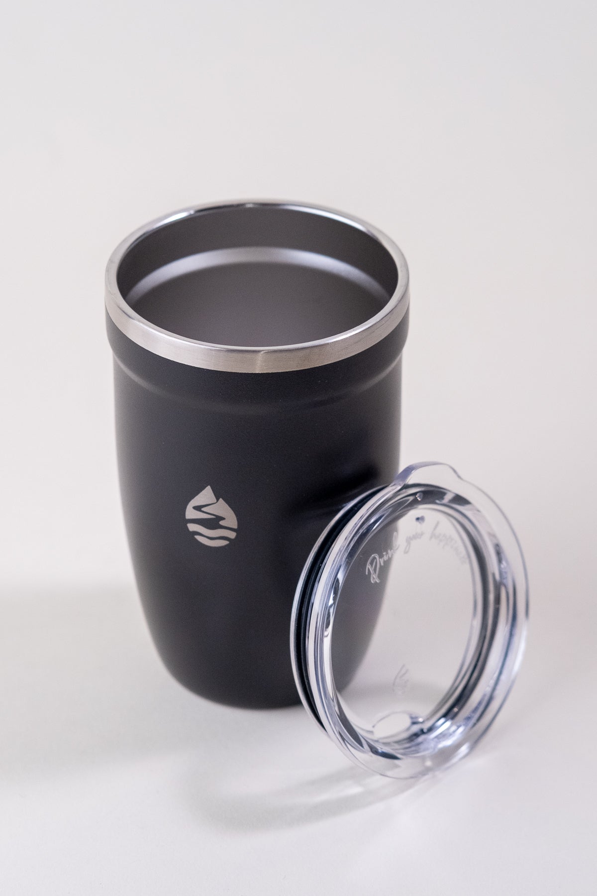 Black insulated tumbler with a stainless steel rim and a removable clear spill-resistant lid. Lamose travel mug designed for hot and cold beverages, featuring a sleek, durable design.