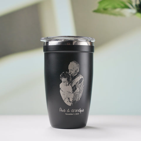 LAMOSE Black insulated tumbler with engraved image of a father holding a baby and the text, perfect for personalized Father's Day gifts.