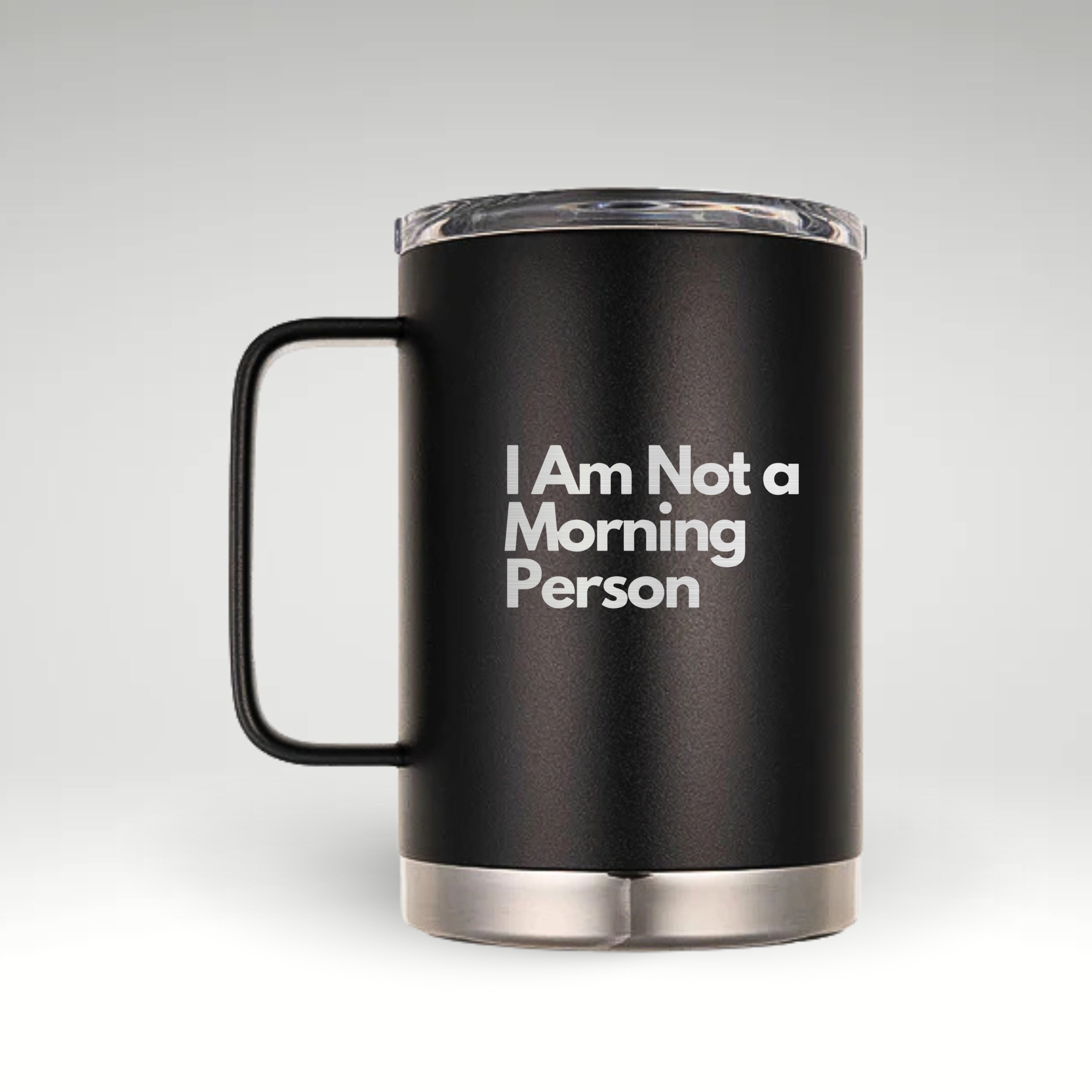 Black insulated mug with a sturdy handle and a clear lid, featuring the engraved phrase "I Am Not a Morning Person" in bold white text. The mug has a sleek matte finish with a stainless steel bottom.
#color_onyx