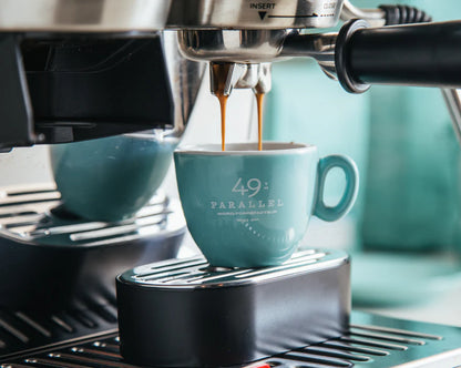 Old School Espresso by 49th Parallel Coffee Roasters. A medium-dark roast with flavors of caramel, dark chocolate, and nuts. Crafted from Indian Ratnagiri Estate and Colombian Tolima Organic beans for a rich and comforting espresso experience.