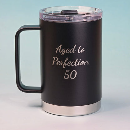 Custom black insulated mug with silver engraving that reads 'Aged to Perfection 50,' perfect for milestone birthday gifts.
