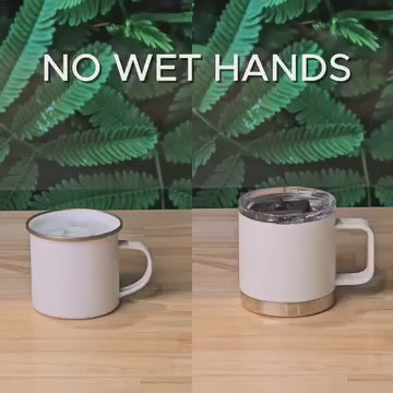 Load video: Comparison of two mugs: an open enamel mug on the left with condensation, and a white insulated mug with a leak-proof lid on the right, preventing wet hands.