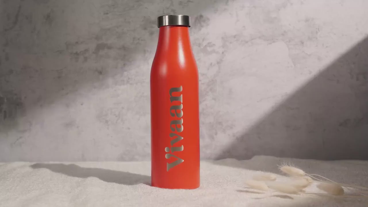 Load video: Four stainless steel water bottles in vibrant colors—turquoise, orange, pastel green, and beige featuring a minimalist engraved logo.